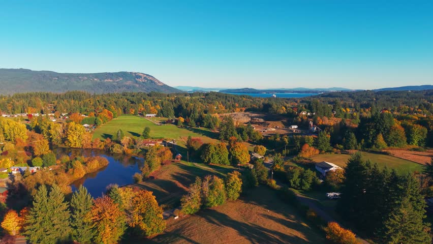 Drone view of Cowichan Valley with river, farmland, forests, and fall colors on Vancouver Island, British Columbia, creating a scenic rural Canadian landscape.