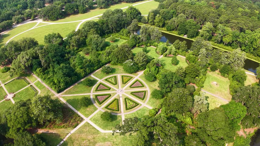 Drone footage shows a circular garden with a radial star design and cross-shaped paths surrounded by lawns and trees at Middleton Place Plantation in Charleston, South Carolina