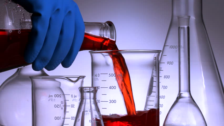 Closeup HD video of scientist pouring red chemical into laboratory glassware
