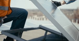 Technician fitting solar panel on rooftop, highlighting renewable energy, sustainable technology, eco-friendly solutions, and clean energy installation. - Powered by Shutterstock - Get 15% off with code: PIKWIZARD15