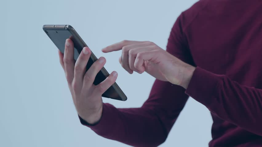 Animation of data processing over man using tablet. Global business, computing, connections and data processing concept digitally generated video.
