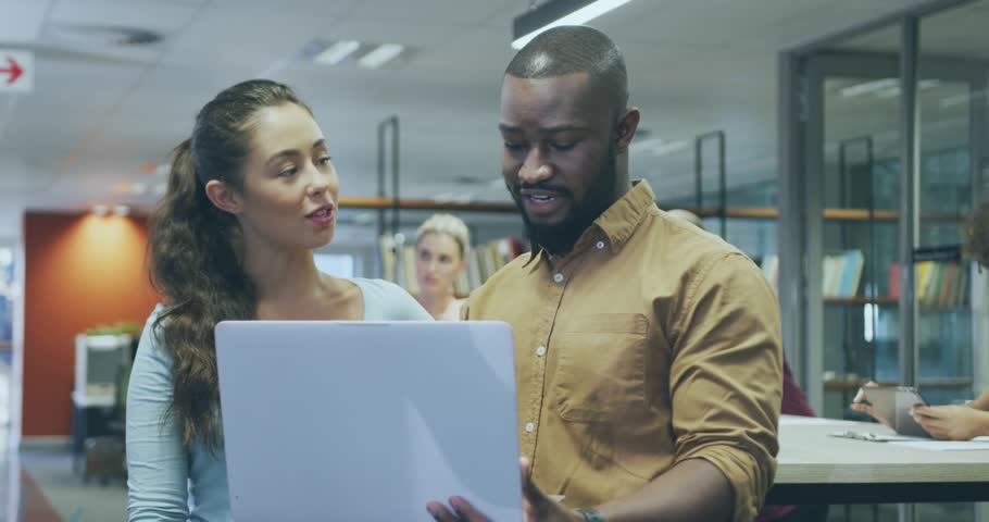 Animation of digital light bulb icons over diverse business people in office. Global business, finances, computing and data processing concept digitally generated video.