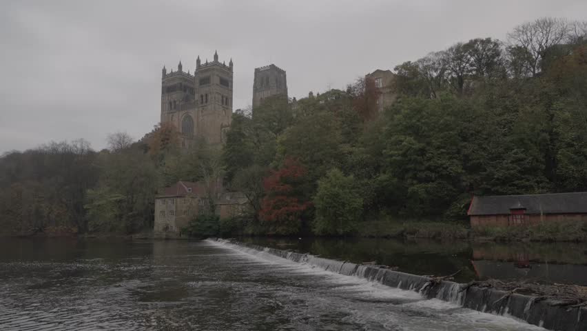 Iconic view of Durham Cathedral and the weir on the River Wear taken in autumn on a gloomy day