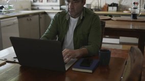 Animation of stay at home text over caucasian man using laptop at home. Global pandemic and digital interface concept digitally generated video. - Powered by Shutterstock - Get 15% off with code: PIKWIZARD15
