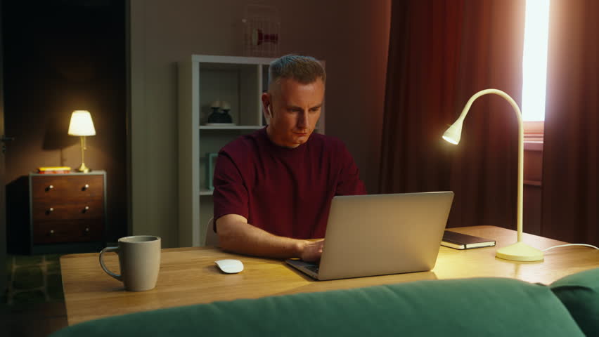 Confident serious man worker work laptop at home. Successful guy looking at camera. Male employee portrait. Busy ceo person use pc. Online education student. Computer freelancer. Distant remote job.