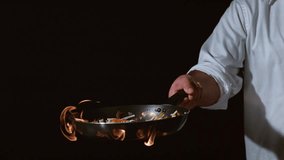"Chef cooking a flaming stir-fry in a professional kitchen, showcasing culinary skills, vibrant flames, and dynamic food preparation action." - Powered by Shutterstock - Get 15% off with code: PIKWIZARD15