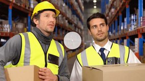 Animation of network of icons over caucasian male worker and supervisor discussing at warehouse. Global networking and logistics business technology concept - Powered by Shutterstock - Get 15% off with code: PIKWIZARD15