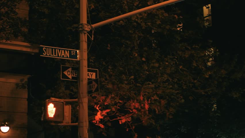 Crosswalk pedestrian signal alternating between walk and stop at a busy Manhattan intersection. Real New York street movement with pedestrians and traffic in 2013