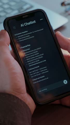 Close-up of a person using an AI chatbot app on their phone to generate business ideas. Virtual assistant with artificial intelligence helps with daily tasks. Conversation with AI application. 