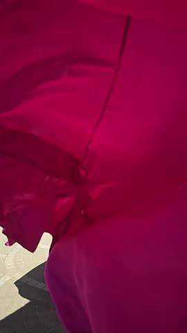 A woman in a bright pink dress poses against the backdrop of a European-style city, a girl in a dress with a long train, flying trail. A beautiful city in an old colonial style, Venice, the Venice of Vietnam