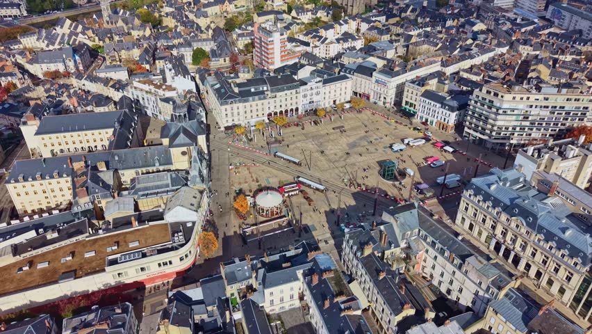 Aerial look over Place de la Republique with Chapelle de la Visitation among dense city blocks, establishing backdrop