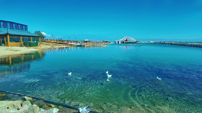 Qinghai Lake, Qinghai Province, China - A Vast, Clear-blue Lake Surrounded by Open Skies and Tranquil Shorelines - Panning Shot
