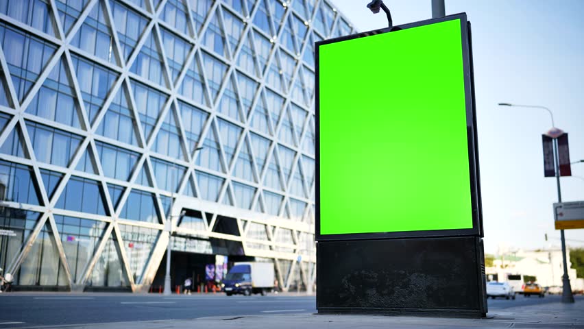 Green screen billboard for advertising mockup on urban street with modern building
