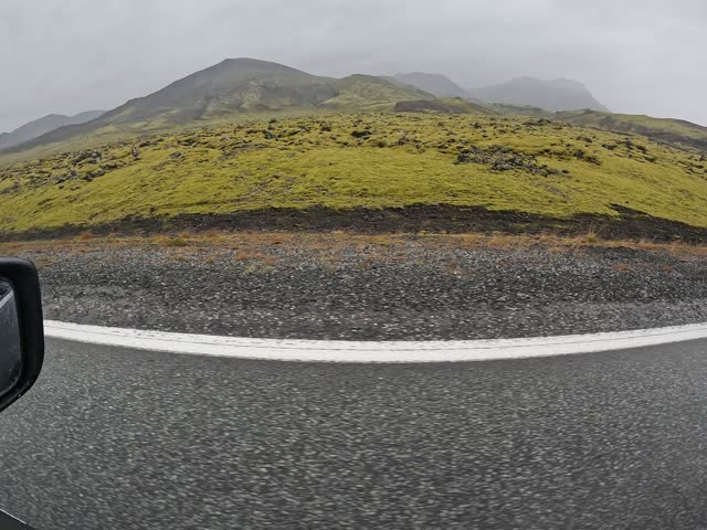 Cinematic POV shot of green Mossy-Lava-Field in Iceland, capturing moody atmosphere during overcast, 4K car footage.