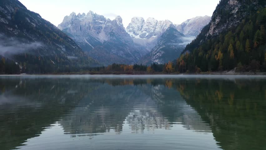 Aerial view of lake with mountain reflection, Italy.