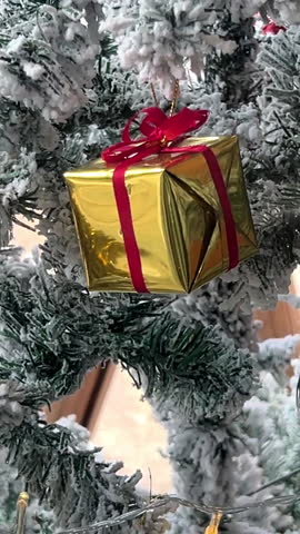 Christmas Tree Ornaments and Festive Decorations Hanging on Branches Close Up