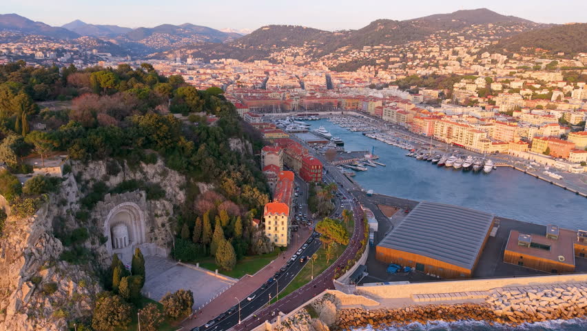 Sunset Coastal Panorama, Drone Captures Seaside Cityscape, Golden Hour View Of Port And Hills. Nice, France