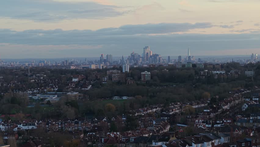London cityscape at dusk, featuring a residential area in the foreground and the city skyline in the background