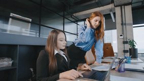 Two businesswoman collaborate in a coworking space focusing on inclusion and diversity with different abilities in a modern business environment - Powered by Shutterstock - Get 15% off with code: PIKWIZARD15