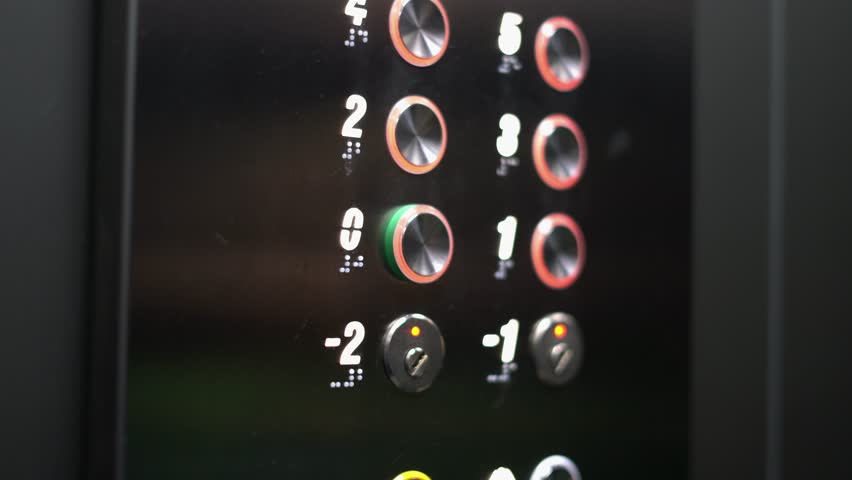 Close up of a person pressing elevator button on modern lift control panel. Concept of choosing floor, transportation, building interior and urban lifestyle.