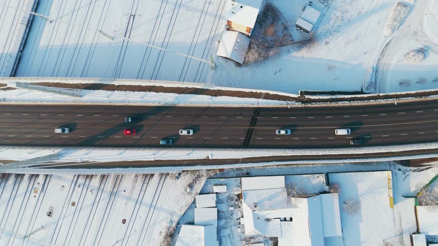 Top-down drone aerial view of Erzsébet Bridge in Békéscsaba, Hungary, with the railway station in the background.