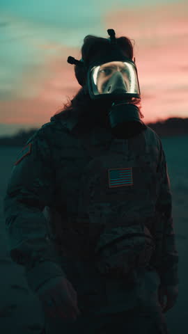 American Soldier Walks on Beach at Sunset Ready for Attack Wearing Gas Mask