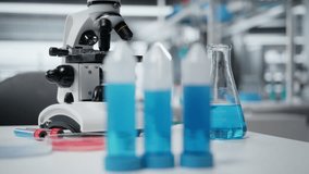Close up of laboratory workbench filled with colorful chemical solutions in glass flasks and beakers. Empty chemistry workspace prepared for liquid reagent experiments and compound testing - Powered by Shutterstock - Get 15% off with code: PIKWIZARD15