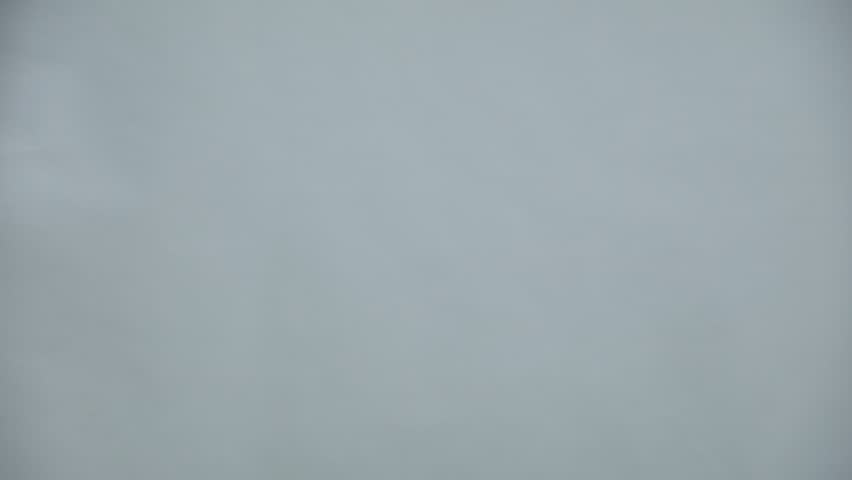 Easter celebration. Cute girl in headband with bunny ears giving wrapped gift on grey background