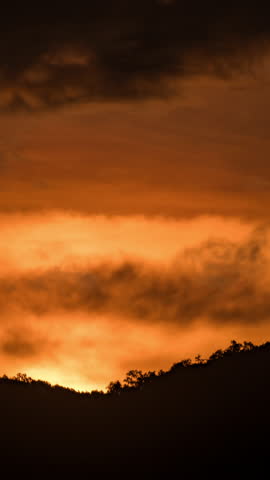 Beautiful sunrise time-lapse over the mountains with soft morning light and moving clouds.