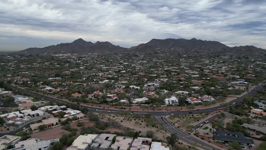 cars driving in scottsdale arizona highway road with mountains background dusk sunset desert neighborhood traffic phoenix az southwest
