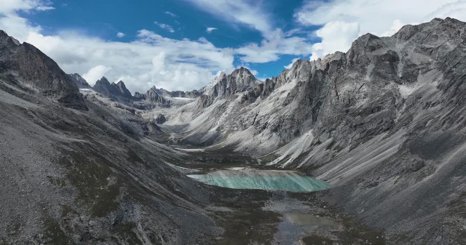 Aerial view of beautiful high altitude lake and snow capped mountain landscape