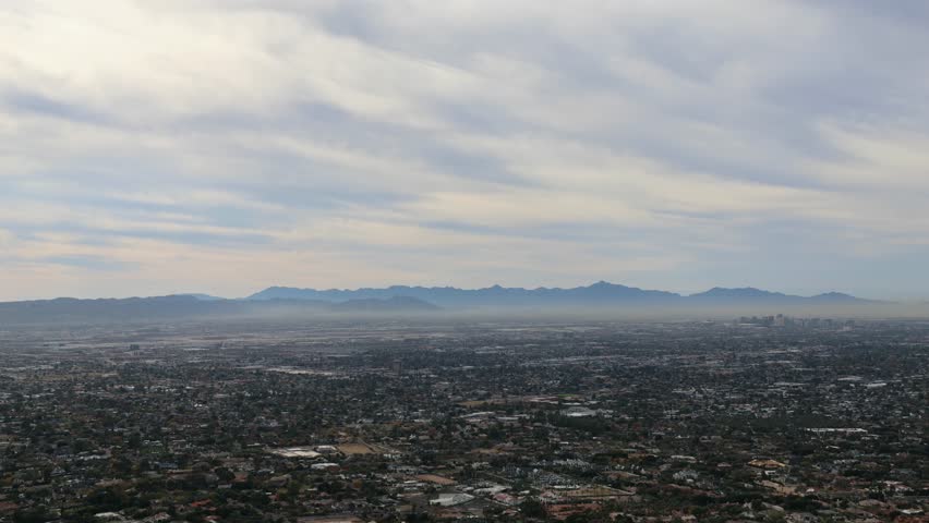phoenix arizona skyline during afternoon daytime (clouds moving overhead skyscrapers commerical district airport) az scottsdale view from camelback mountain desert southwest neighborhood town view
