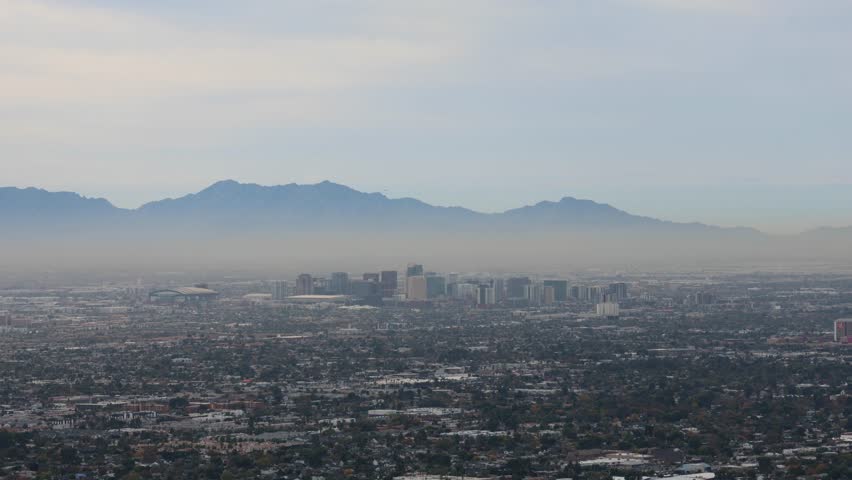 phoenix arizona skyline during afternoon daytime (clouds moving overhead skyscrapers commerical district airport) az scottsdale view from camelback mountain desert southwest neighborhood town view