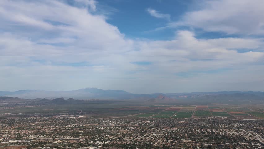 phoenix arizona skyline during afternoon daytime (clouds moving overhead skyscrapers commerical district airport) az scottsdale view from camelback mountain desert southwest neighborhood town view