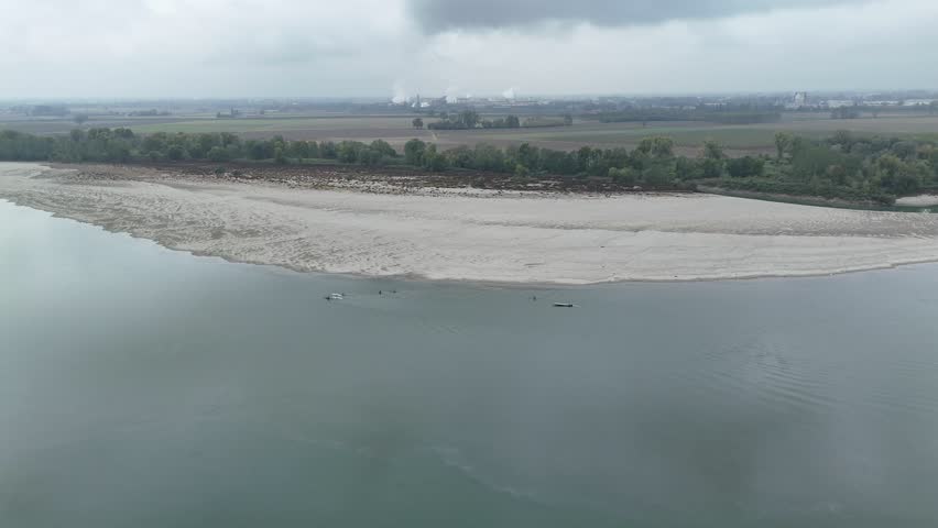 Aerial view of the River Po at sunset near Cremona, capturing the tranquil winter landscape of the Cremona, Lombardy, regional border with Emilia Romagna, Italy.