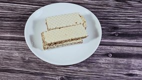 The layers of wafer biscuits filled with creamy chocolate, a wafer is a crisp, sweet, very thin, flat, light biscuit, creamy chocolate sandwiched in wafers, treat biscuit - Powered by Shutterstock - Get 15% off with code: PIKWIZARD15