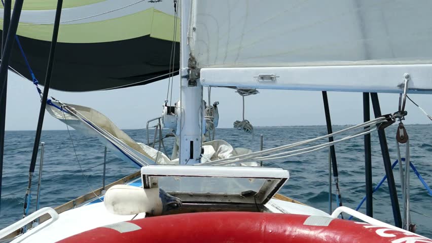 Beautiful sailing experience on a luxury yacht navigating calm blue seas, surrounded by endless ocean views and tranquility in tropical scenery.