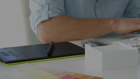 Animation of network of connections over mid section of male graphic designer using graphic tablet. Global networking and business technology concept - Powered by Shutterstock - Get 15% off with code: PIKWIZARD15