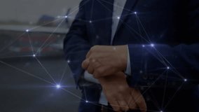 Animation of network of connections over caucasian businessman using smartwatch at an airport. Global networking and business technology concept - Powered by Shutterstock - Get 15% off with code: PIKWIZARD15