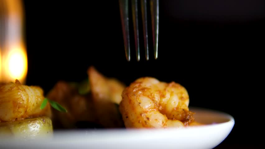 Eating Rare Cooked Beef Steak With Fork And Steak Knife, Served With White Rice And Shrimp Kebab In A Sizzling Plate. close up