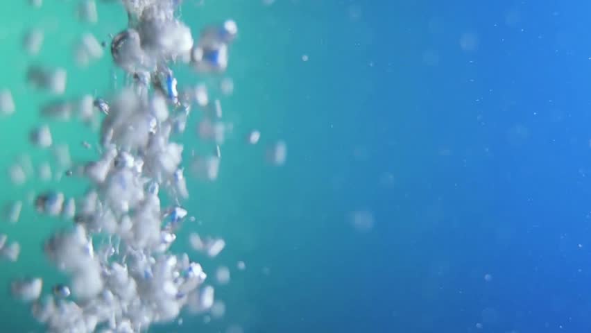 Stream of rising bubbles in Clear Blue Water. Light creating shimmering. Ideal for backgrounds, visual effects, aquatic themed project, abstract designs or simulating an aquarium or underwater.