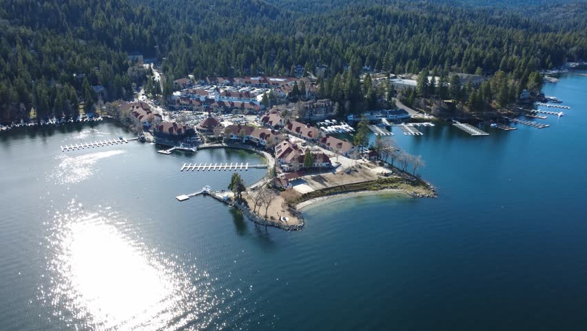 Lake Arrowhead Village in San Bernardino County, Southern California. Slow aerial drone approaching the busy commercial area.