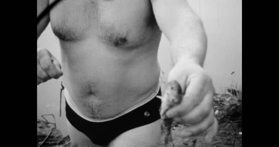 Close-up of a Mans Hand Holding a Small Caught Fish, Archival Footage, Intimate Look at Handling a Small Fish After the Catch