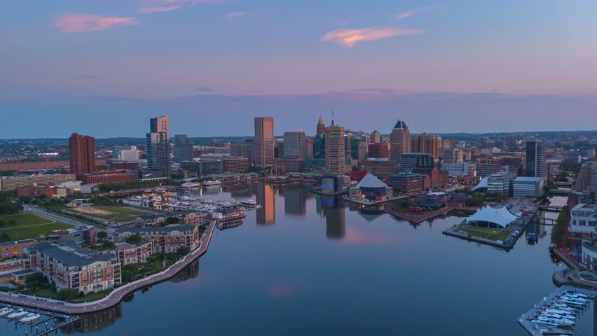 Baltimore Maryland, inner harbor at dawn, sunrise, drone push in time lapse shot