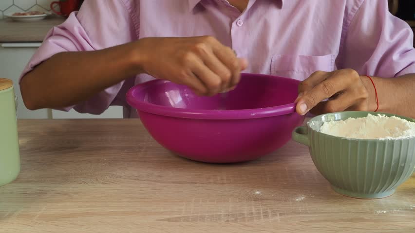 A man prepares and rolls out dough for pizza and pie