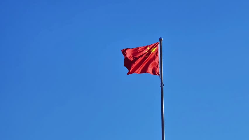 China"s Five starred red flag under the blue skk.