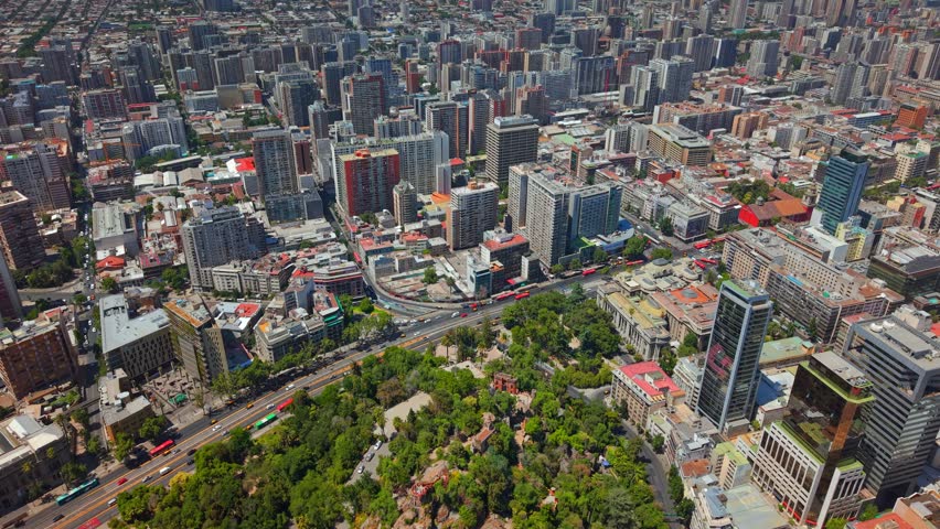 Aerial Establishing fly Santiago de Chile City, Santa Lucia Hill Urban Park and Dense Residential Buildings