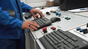 Close-up of skill technician's hands operating CNC machine at manufacturing factory. Operator in production shop during high-tech workflow. Setting up and programming production equipment and machine. - Powered by Shutterstock - Get 15% off with code: PIKWIZARD15