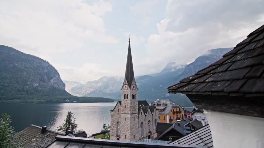 Hallstatt church Austria architecture. City urban landscape with cathedral on lake shore in Alps, tourist Europe.