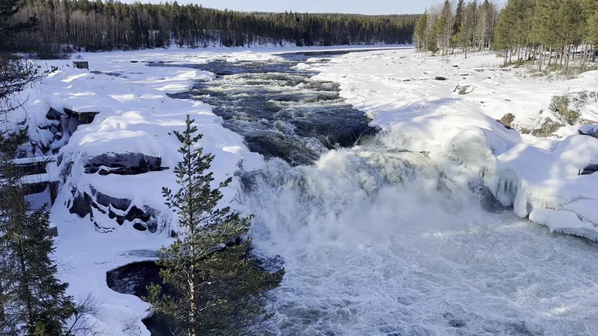 Aerial Landscape of Kalix Waterfall and Flowing River in Snowy Swedish Lapland